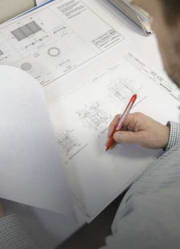 A man reviewing engineering plans